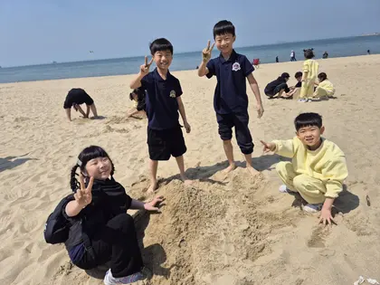 바닷가 모래사장에서 노는 친구들